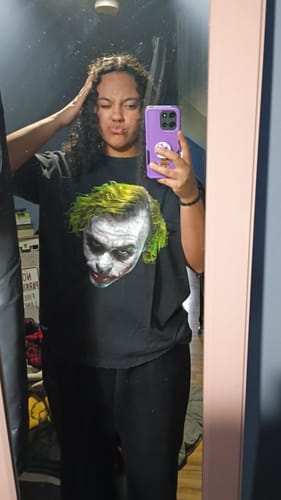 Reviewer wearing a black Batman Midnight Tee with a large Joker graphic.