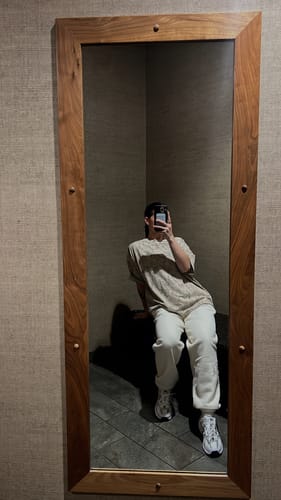 Reviewer sitting down, showing the roomy fit of the off-white Layover Cuff Joggers in a mirror selfie.