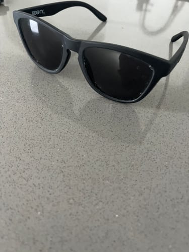 Customer's 80Eighty Polarized Shady Sunglasses with a matte black frame on a countertop.