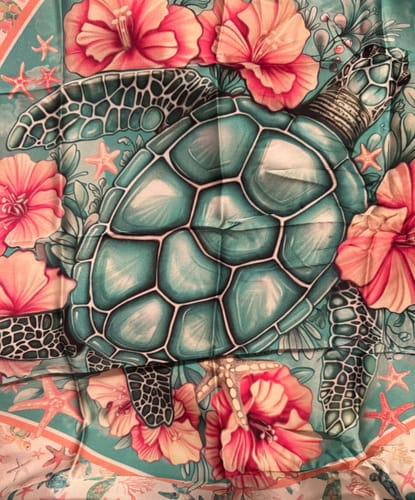 Customer's detailed Trust The Journey Turtle Scarf showing a large teal turtle surrounded by pink flowers.