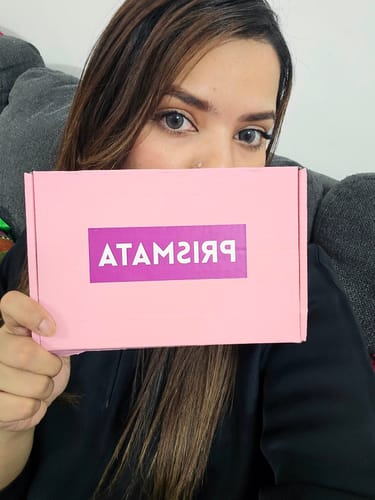 Customer wearing light grey Innocent Smoke Grey Contact Lenses while holding a pink box.