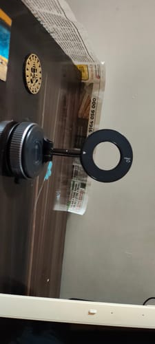 A customer's cable protector mounted on a dark wooden surface, ready for use.