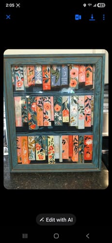 Customer's completed Floral tales Paint by Number artwork, presented as floral book spines in a painted blue shadow box frame.