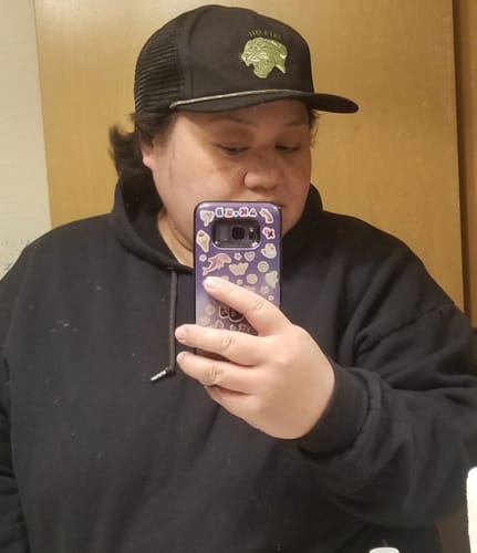 Reviewer taking a selfie while wearing the black Big Flat Bill Unstructured Rope Mesh Hat.
