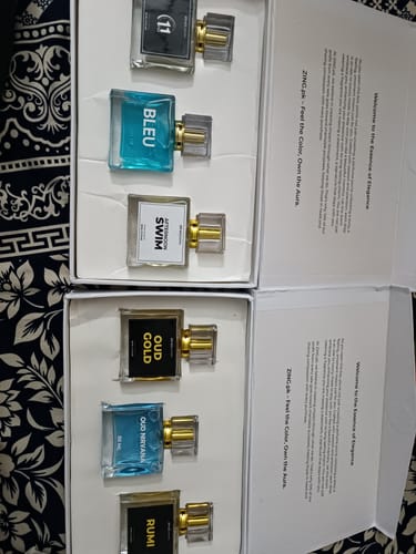 Customer's two fragrance sets, including the OUD Supreme Bundle, displayed in their open white boxes.