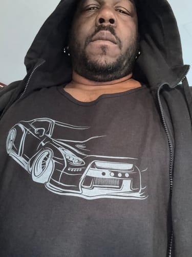 Customer wearing the black 80Eighty® Frontline Tank with a white car graphic under a black hoodie.