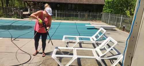 Reviewer wearing the white Ladies Ponytail Faith Hat while power washing by a pool.