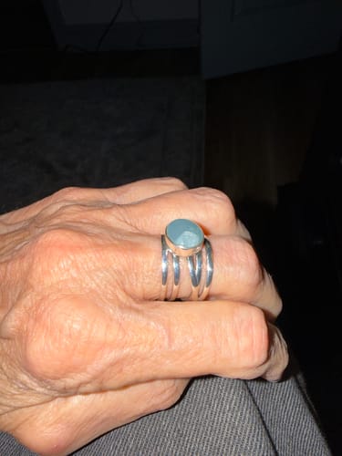 Customer's hand wearing the Chunky Aquamarine Wrap Ring, showing the sterling silver band and oval stone.