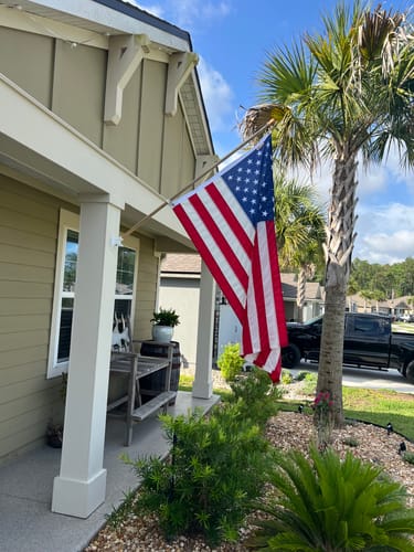 Customer's Heavy Duty American Nylon Flag flying from the front porch of a house.
