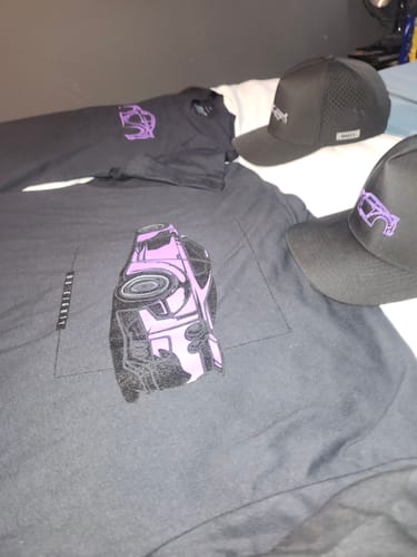 Reviewer's two black 80Eighty DCG88 Hats displayed with two graphic t-shirts on a flat surface.
