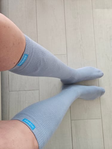 Customer's view of their legs wearing the light blue Performance Eucalyptus Compression Socks.