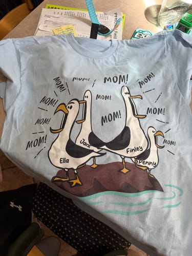 Reviewer's personalized light blue 'Seagull Mom Mom Mom' shirt with the names Ella, Jack, Finley, and Penny on the seagulls.