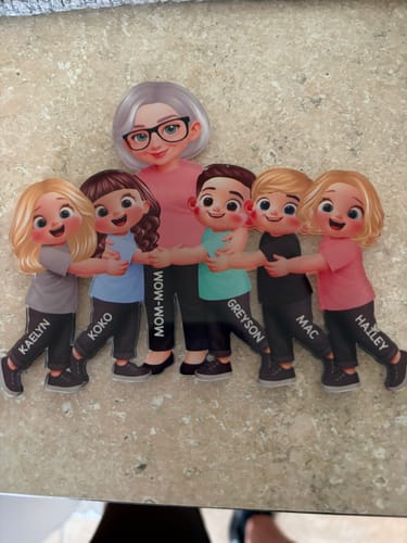 Customer's personalized acrylic fridge magnet featuring a grandma character being hugged by five grandchildren.