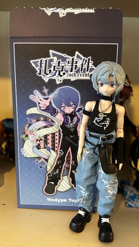 Customer's Zack Event Series BJD figure, the tattoo artist, posed next to its original blind box.