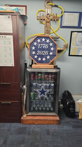 Customer's 1776 to 2026 Betsy Ross Flag presented in a custom octagonal display case in an office.