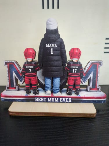 Reviewer's personalized 2-layered wooden plaque showing a hockey mom and two children on a stand reading 'BEST MOM EVER'.