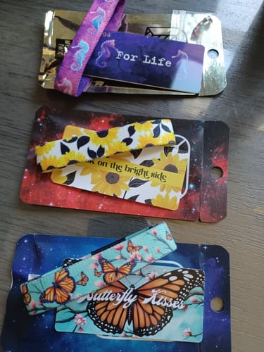 Customer's Mystery 3-Pack showing the 'For Life' seahorse, 'Look on the Bright Side' sunflower, and 'Butterfly Kisses' straps.