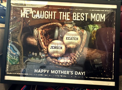 Customer's framed 'We Caught The Best Mom' poster, showing two baseballs personalized with 'Jensen' and 'Keaten' in a glove.