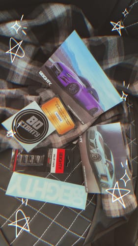 Customer's 80Eighty Valve Stem Caps in their packaging, shown with branded stickers and postcards.