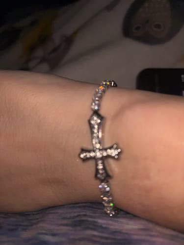 Close-up of a customer wearing the elegant Zircon-Encrusted Cross Bracelet on their wrist.