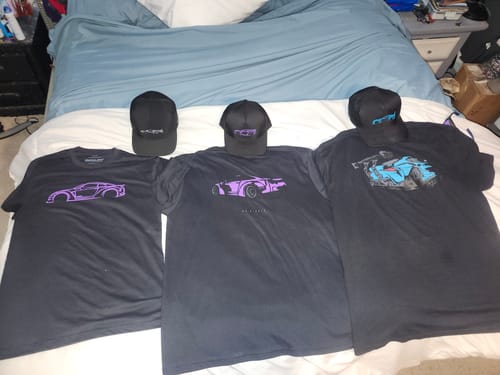 Customer's collection of three black 80Eighty shirts and hats laid out on a bed, with the DCG88 Shirt in the center.