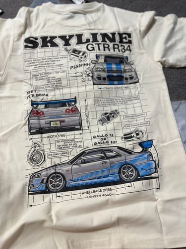 Customer's cream-colored Skyline Project T-Shirt laid out, showing the detailed car blueprint graphic.