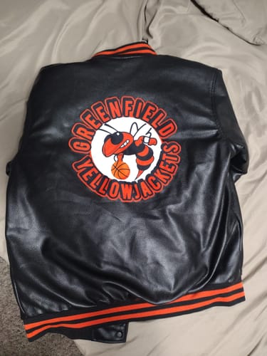 Reviewer's custom black and orange faux leather jacket showing the 'Greenfield Yellowjackets' logo on the back.