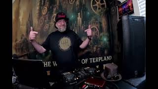 Reviewer wearing the black 6Speed = Jail Shirt with a large gold graphic while standing behind DJ equipment.