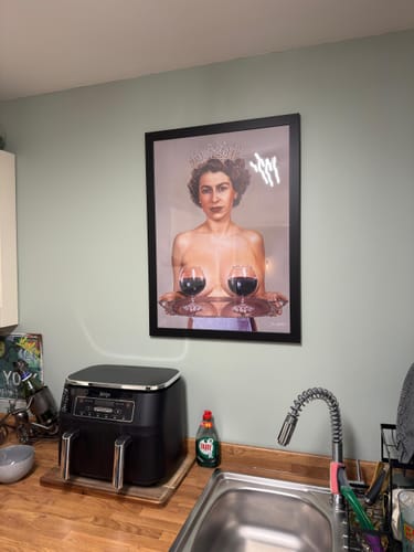 Customer's framed Majestic art print hanging on a kitchen wall above a counter and sink.