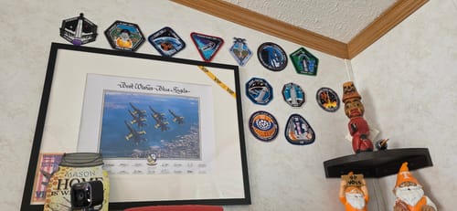 Customer's Starship Flight 12 Collectors Patch displayed on a wall among a large collection of other patches.