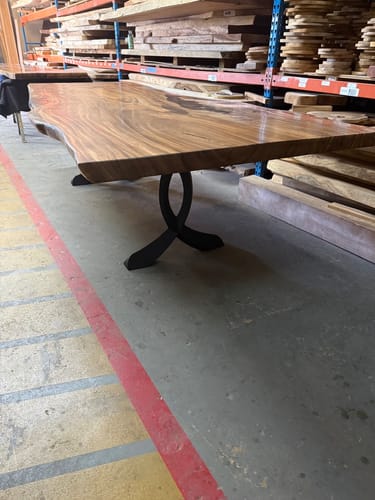 Customer's custom table with a long live-edge wood slab and black 418 Curva dining table legs.