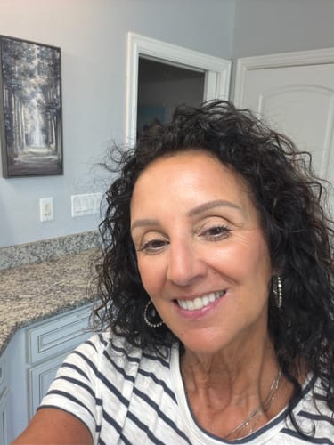 Customer shows her happy, smiling face after using Koriderm™ Time Reverse Cream.