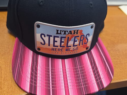 Customer's custom Utah Plate Hat with 'Steelers' text on the patch and a pink striped brim.