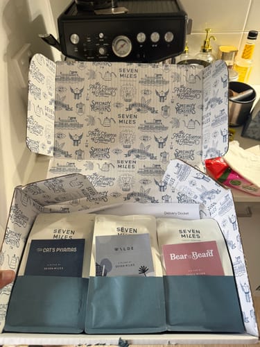 Customer's open Coffee Blend Sampler Pack, showing three different coffee bags inside the branded box.