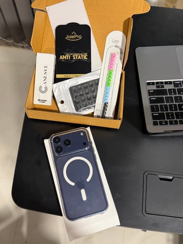 Customer displays the Anti Yellow Magsafe Clear Case on a blue phone, with other products from the box.