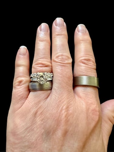 Reviewer's hand showing the Semi Eternity Ring worn in a stack on their ring finger.
