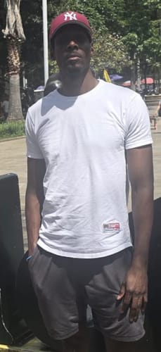 Reviewer standing outdoors wearing the White Long Body Patch 2.0 t-shirt, showing the fit.
