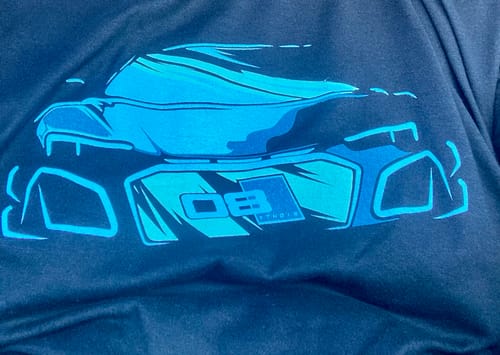 Close-up of a customer's black Cobalt Beast Shirt, showing the stylized blue car graphic.