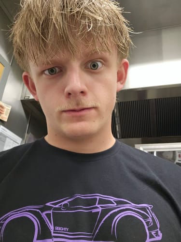 Reviewer in a black Duplicate Pop DCG88 Shirt with a purple car graphic.