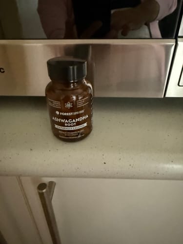 Customer's bottle of Mini Pure Ashwagandha Root Capsules sitting on a kitchen counter.