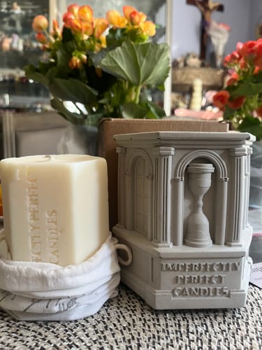 Customer's The Monument cement vessel shown with the candle refill sitting in its white cloth bag.