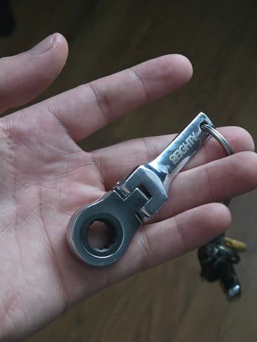 Customer holding the silver 80Eighty 10mm Wrench Keychain in the palm of their hand.