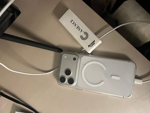 Customer's Anti Yellow Magsafe Clear Case on an iPhone, showing the phone charging on a desk.