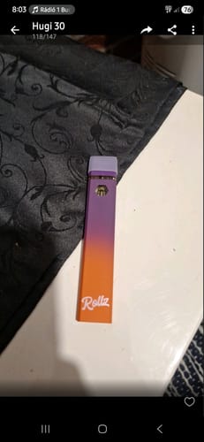Customer's purple and orange ROLLZ 10-OH Superior LIVE RESIN VAPE sitting on a table.