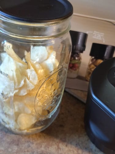Customer's mason jar filled with potato chips, sealed with a black Chalkboard Top Lid.