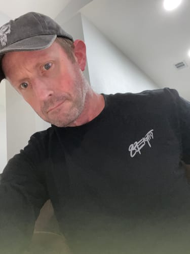 Reviewer wearing their black 80Eighty® Signature LS Shirt, showing the white logo on the chest.