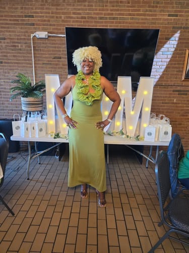 Customer wearing the green Naked Ruffle Halter Maxi Dress in a full-length view at an event.