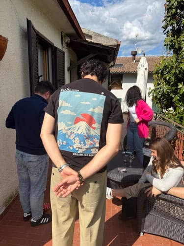 Reviewer seen from behind, showing the large, colorful back graphic on the Fuji Blossom T-Shirt.
