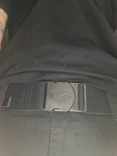 Close-up of a reviewer from behind wearing the black 80Eighty Resilient Belt around their waist.