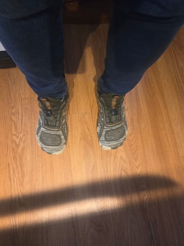 Reviewer's top-down view of their Active II Pro - Barefoot Shoes being worn on a wooden floor.